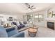 Open living space connecting to kitchen with fireplace, sofa, and chairs. The layout is great for entertaining guests at 2648 E Teakwood Pl, Chandler, AZ 85249