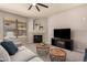 Cozy living room features a fireplace, ceiling fan, and stylish furniture, perfect for relaxing and entertaining guests at 2648 E Teakwood Pl, Chandler, AZ 85249