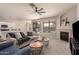 Cozy living room with fireplace, comfortable seating, and an open floor plan to the kitchen at 2648 E Teakwood Pl, Chandler, AZ 85249