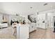 Bright open-concept living space connects kitchen, living room, and staircase with black iron railing at 2648 E Teakwood Pl, Chandler, AZ 85249