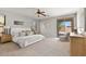 Spacious main bedroom with soft carpet, neutral colors, and private backyard access at 2648 E Teakwood Pl, Chandler, AZ 85249