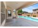 Covered patio offers a view of the private pool and lush landscaping, perfect for outdoor relaxation at 2648 E Teakwood Pl, Chandler, AZ 85249