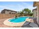 Inviting backyard featuring a private pool with a rock feature and ample patio space at 2648 E Teakwood Pl, Chandler, AZ 85249