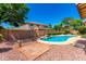 This beautiful pool is surrounded by lush landscaping and rock features, perfect for hot summer days at 2648 E Teakwood Pl, Chandler, AZ 85249