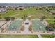 Overhead view of community park with basketball courts, green spaces, and walking paths for recreation at 30963 W Columbus Ave, Buckeye, AZ 85396