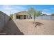 Spacious backyard with desert landscaping, a covered patio, and block fencing at 30963 W Columbus Ave, Buckeye, AZ 85396
