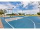 Well-maintained blue basketball court featuring modern hoops and lighting for evening games at 30963 W Columbus Ave, Buckeye, AZ 85396