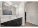 Bathroom with double vanity, lots of light and a large mirror with a dark cabinet base at 30963 W Columbus Ave, Buckeye, AZ 85396