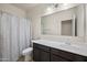 Clean bathroom featuring a vanity with sink and a shower-tub combo with curtain at 30963 W Columbus Ave, Buckeye, AZ 85396