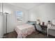 Cozy bedroom with a bed, desk, vanity, and natural light from the window at 30963 W Columbus Ave, Buckeye, AZ 85396