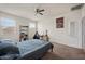 Cozy bedroom featuring neutral walls, carpet flooring, ceiling fan, and natural light at 30963 W Columbus Ave, Buckeye, AZ 85396