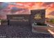 Inviting Tartesso Community Park entrance sign, beautifully landscaped and set against a striking sunset sky at 30963 W Columbus Ave, Buckeye, AZ 85396
