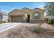 Charming single-story home with a two-car garage and well-maintained desert landscaping at 30963 W Columbus Ave, Buckeye, AZ 85396