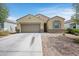 Attractive single-story home with a two-car garage and low-maintenance desert landscaping at 30963 W Columbus Ave, Buckeye, AZ 85396