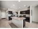 The kitchen features a large island, stainless steel appliances, and plenty of cabinet space for storage at 30963 W Columbus Ave, Buckeye, AZ 85396