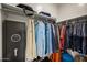 Organized walk-in closet with shelving, hanging rods, and a secure safe for valuables at 30963 W Columbus Ave, Buckeye, AZ 85396