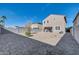 Backyard showcasing a gravel-covered area, block fencing, and ample space for outdoor activities at 36085 W Prado St, Maricopa, AZ 85138