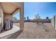 Low-maintenance backyard with rock landscaping, covered patio, and privacy wall at 36085 W Prado St, Maricopa, AZ 85138