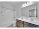 Bright bathroom with double sinks, modern fixtures, and a shower-tub combo at 36085 W Prado St, Maricopa, AZ 85138