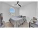 Cozy bedroom with ceiling fan, neutral carpet, and a window view at 36085 W Prado St, Maricopa, AZ 85138