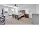 Bright bedroom with carpet, a ceiling fan, natural light, and classic dark wood furniture at 36085 W Prado St, Maricopa, AZ 85138