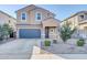 Charming two-story home featuring a neutral color scheme, arched windows and a two car garage at 36085 W Prado St, Maricopa, AZ 85138