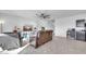 Bright living room showcasing neutral tones, tile flooring, a large TV, and comfortable leather seating at 36085 W Prado St, Maricopa, AZ 85138