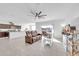 Spacious living room featuring tile floors, ceiling fan, and sliding glass doors for natural light and outdoor access at 36085 W Prado St, Maricopa, AZ 85138