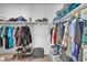 This walk-in closet includes shelving and hanging storage for clothing and accessories at 36085 W Prado St, Maricopa, AZ 85138