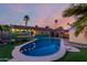 Backyard oasis with a sparkling pool, cozy patio, and well maintained landscaping at 3643 E Friess Dr, Phoenix, AZ 85032