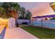 Spacious backyard with a storage shed, outdoor seating, and a decorative fence and lights at 3643 E Friess Dr, Phoenix, AZ 85032