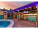 Cozy covered patio with hanging lights and stylish wicker chairs overlooking the pool at 3643 E Friess Dr, Phoenix, AZ 85032