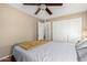 Bedroom with closet featuring a ceiling fan, closet and a large window at 3643 E Friess Dr, Phoenix, AZ 85032