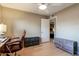 Neutral bedroom with a fan, an office chair and desk, and drawers for storage at 3643 E Friess Dr, Phoenix, AZ 85032