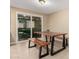 Dining room features a wood table, benches, tile floors and sliding glass doors at 3643 E Friess Dr, Phoenix, AZ 85032