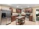 Well-lit kitchen features stainless steel appliances, dark wood cabinetry and island at 3643 E Friess Dr, Phoenix, AZ 85032
