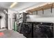 Spacious laundry room featuring modern washer and dryer, and some shelving at 3643 E Friess Dr, Phoenix, AZ 85032