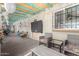 Enclosed outdoor patio with seating, fans, and decorative touches at 3643 E Friess Dr, Phoenix, AZ 85032