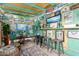 Unique indoor patio, fully decorated with surfboards, art, and stools around counter at 3643 E Friess Dr, Phoenix, AZ 85032