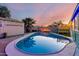Inviting backyard pool surrounded by lush landscaping and a private shed, perfect for relaxation at 3643 E Friess Dr, Phoenix, AZ 85032