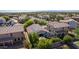 An aerial view showcases a lush backyard with a covered patio and mature landscaping at 3823 S 101St Dr, Tolleson, AZ 85353