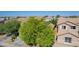 Aerial shot of a suburban home featuring a lush green tree, and neatly maintained yards at 3823 S 101St Dr, Tolleson, AZ 85353
