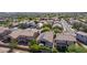 An aerial image of the neighborhood shows mature landscaping, lush green lawns, and solar panels at 3823 S 101St Dr, Tolleson, AZ 85353