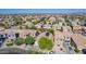 Neighborhood with well-maintained homes, tile roofs, and neat landscaping from above at 3823 S 101St Dr, Tolleson, AZ 85353