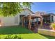 Expansive backyard featuring a gazebo, outdoor seating, lush green lawn, and manicured landscaping at 3823 S 101St Dr, Tolleson, AZ 85353