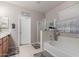 Bright bathroom with a tub, stand up shower and a vanity with great lighting at 3823 S 101St Dr, Tolleson, AZ 85353