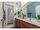 Dual sink bathroom with great lighting, blue accent wall and neutral tones at 3823 S 101St Dr, Tolleson, AZ 85353