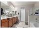 Well-lit bathroom with double vanities, a soaking tub, and modern fixtures at 3823 S 101St Dr, Tolleson, AZ 85353