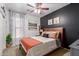 Stylish bedroom featuring a cozy bed, ceiling fan, and natural light from the window at 3823 S 101St Dr, Tolleson, AZ 85353