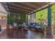 Relaxing covered patio with comfortable seating, lush greenery, and a stylish pergola at 3823 S 101St Dr, Tolleson, AZ 85353